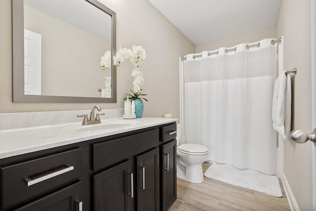 full bath with vanity, curtained shower, toilet, and wood finished floors