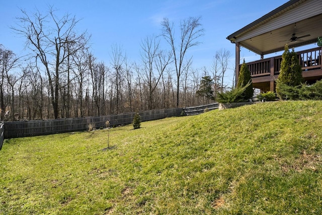 view of yard featuring fence and ceiling fan