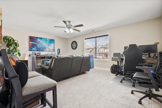 office area featuring light carpet, ceiling fan, and baseboards