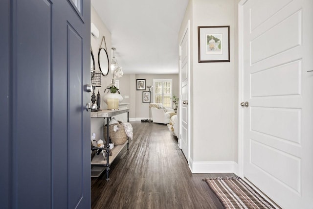 entryway with baseboards and dark wood finished floors