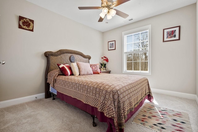 carpeted bedroom with a ceiling fan, baseboards, and visible vents