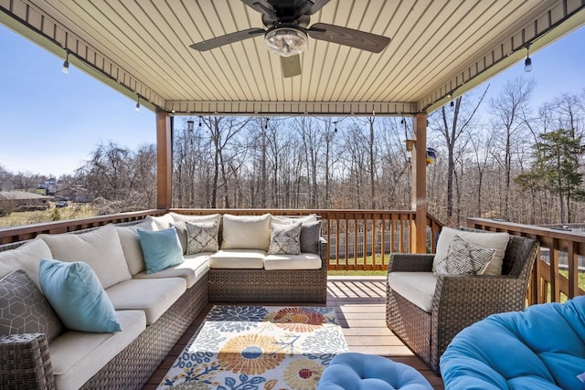 wooden terrace featuring an outdoor living space and ceiling fan