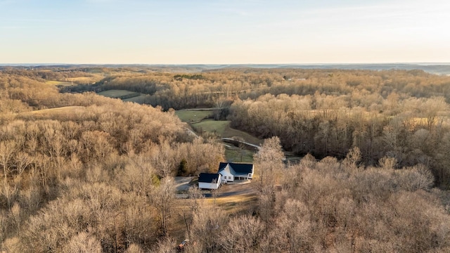 bird's eye view with a wooded view