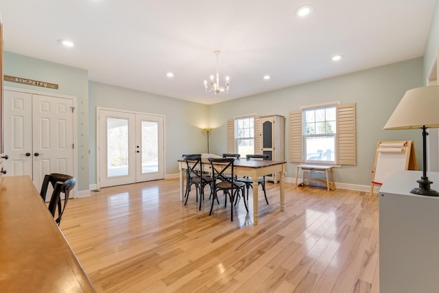 dining room featuring french doors, light wood-type flooring, an inviting chandelier, and recessed lighting