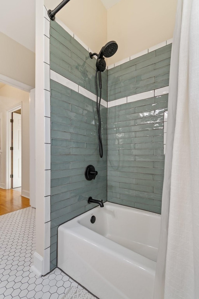 full bathroom with shower / bath combo with shower curtain and tile patterned floors