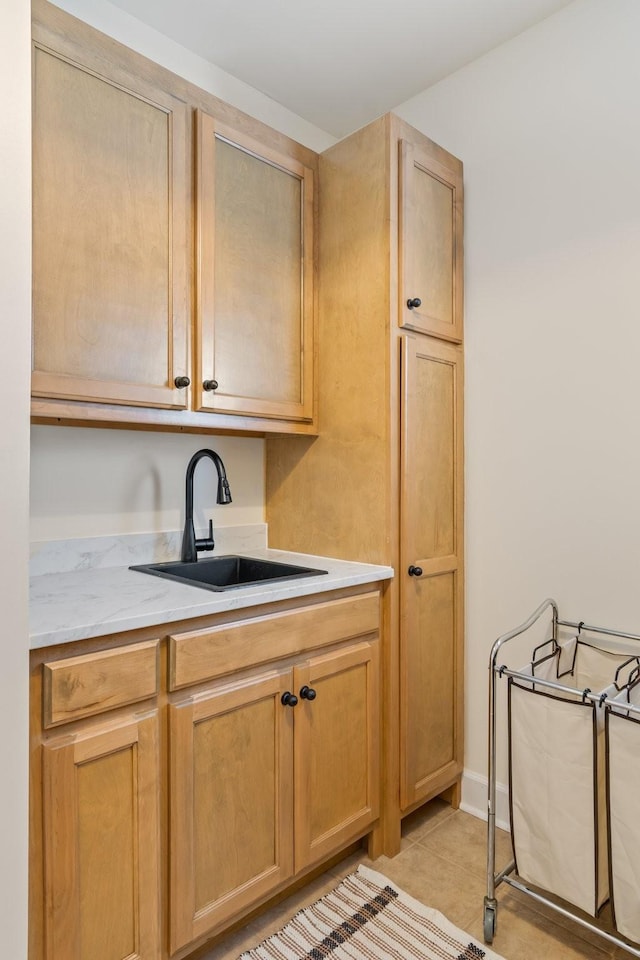 kitchen with light countertops, a sink, and light tile patterned flooring