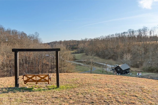 view of yard featuring a forest view