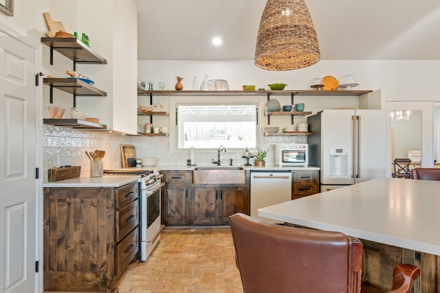 kitchen with white appliances, a sink, decorative backsplash, and open shelves