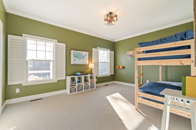 carpeted bedroom featuring baseboards, visible vents, and ornamental molding