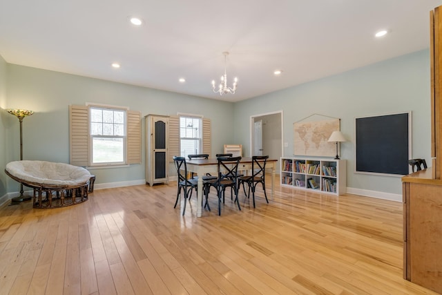 dining room with light wood-style flooring, a chandelier, baseboards, and recessed lighting