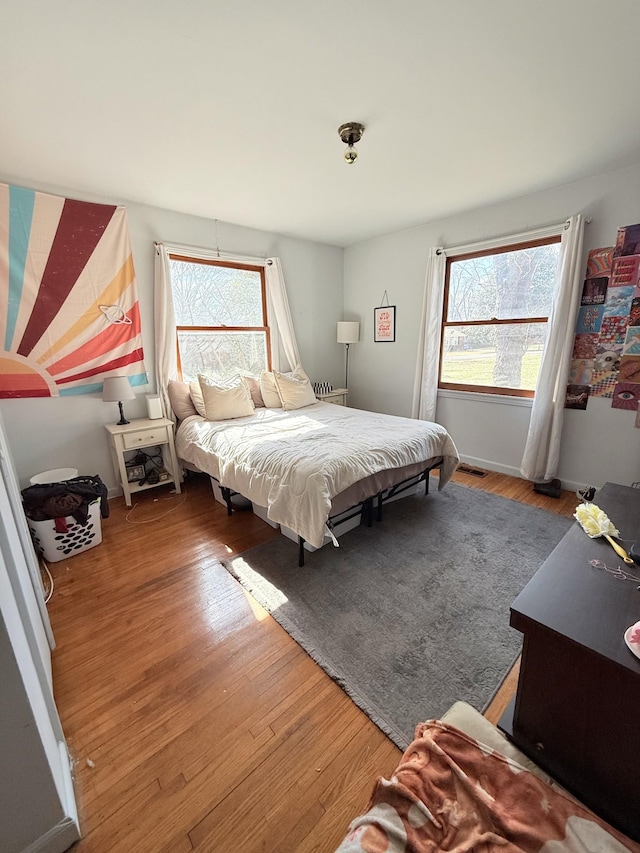 bedroom featuring baseboards and wood finished floors