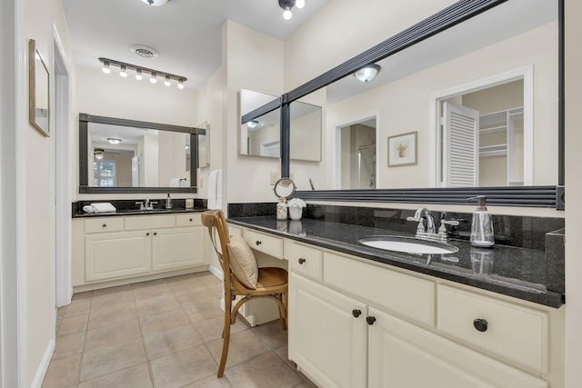 bathroom with visible vents, tile patterned flooring, vanity, and rail lighting