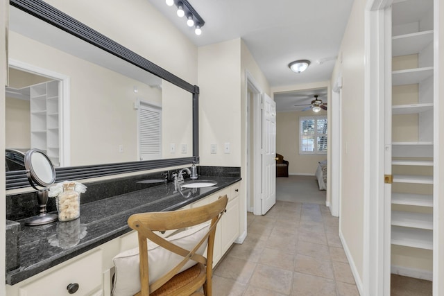 bathroom with tile patterned floors, baseboards, a ceiling fan, and vanity