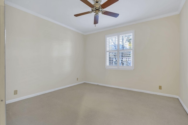 unfurnished room featuring baseboards, ornamental molding, a ceiling fan, and light colored carpet