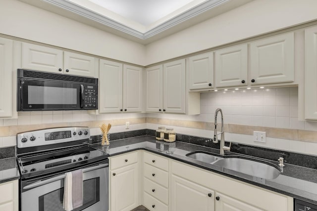 kitchen with black microwave, electric range, a sink, decorative backsplash, and dark stone counters