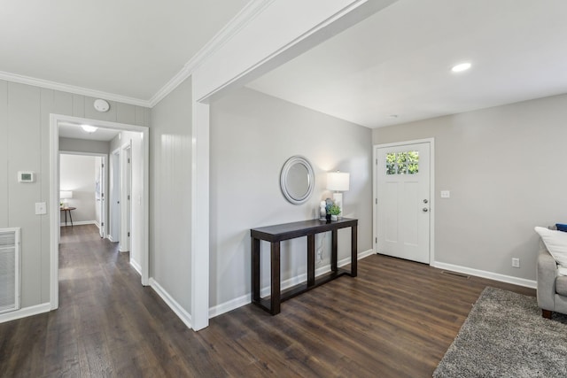 foyer featuring ornamental molding, dark wood-style flooring, visible vents, and baseboards