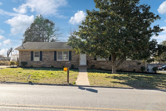 view of front of property with a front lawn and brick siding