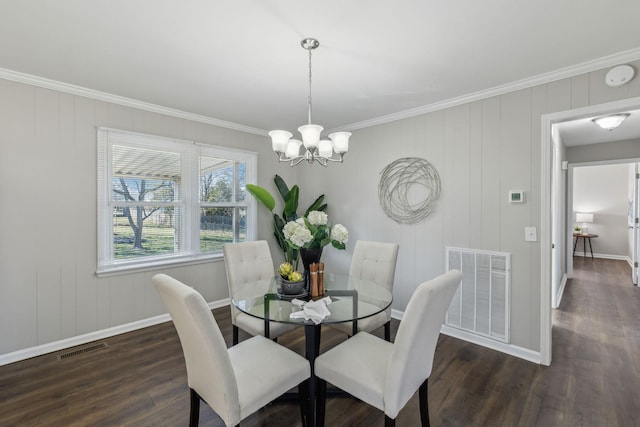 dining room featuring a chandelier, wood finished floors, visible vents, and baseboards