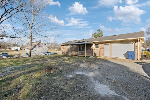 view of front of home featuring a garage, driveway, and brick siding