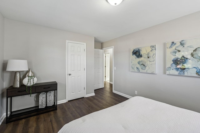 bedroom featuring wood finished floors and baseboards