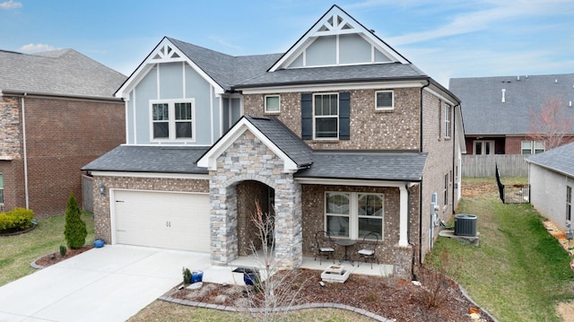 view of front of home featuring concrete driveway, a shingled roof, central AC, and an attached garage