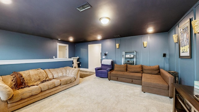 cinema room with visible vents and carpet flooring