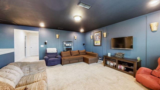 living area with carpet floors, visible vents, and a decorative wall