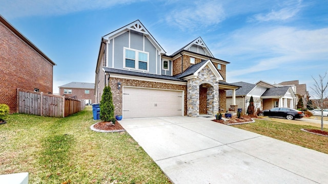 craftsman-style house featuring a garage, concrete driveway, stone siding, fence, and a front lawn