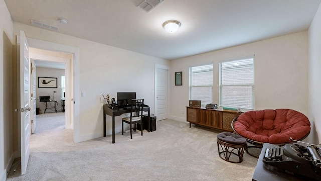 carpeted office with baseboards and visible vents