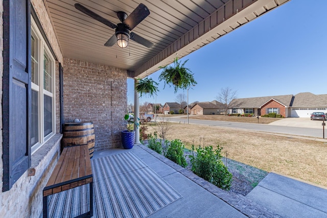 view of patio / terrace with ceiling fan and a residential view