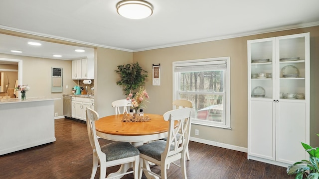 dining area featuring dark wood-style floors, ornamental molding, and baseboards