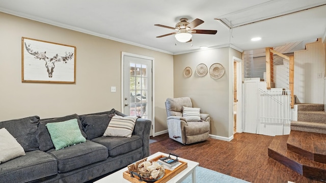 living area with baseboards, ornamental molding, stairway, dark wood-style floors, and attic access