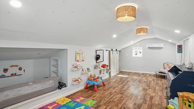 recreation room with lofted ceiling, baseboards, wood finished floors, and a wall mounted AC