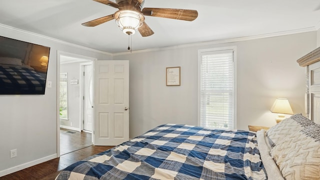 bedroom featuring multiple windows, wood finished floors, and crown molding