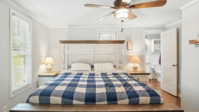 bedroom with multiple windows, ornamental molding, and wood finished floors