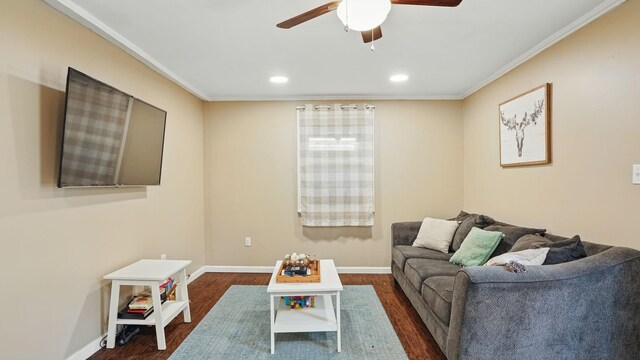 living area with ceiling fan, crown molding, dark wood-style flooring, and baseboards