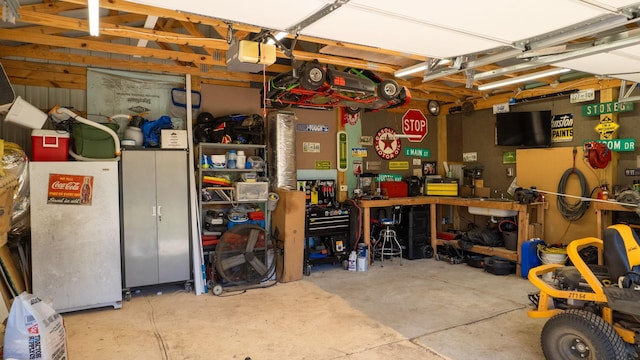 garage featuring a workshop area and a garage door opener