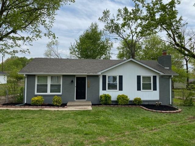 single story home with a front lawn and a chimney