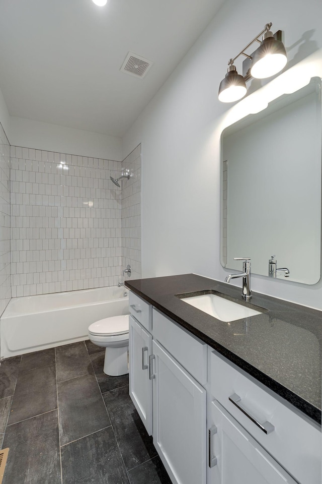 bathroom featuring visible vents, vanity, toilet, and bathing tub / shower combination