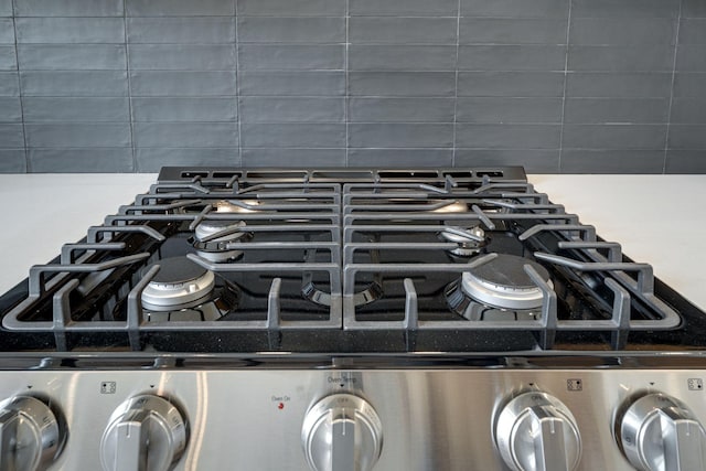 room details featuring stainless steel gas stove and backsplash