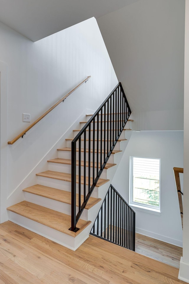 stairs featuring wood finished floors