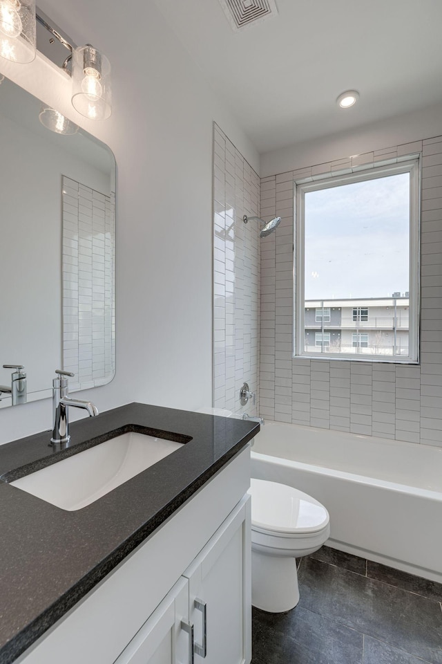 bathroom featuring visible vents, shower / bathing tub combination, vanity, and toilet