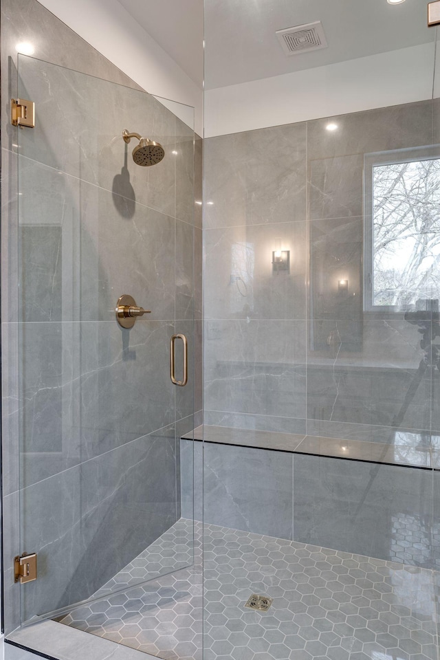 bathroom featuring a stall shower and visible vents