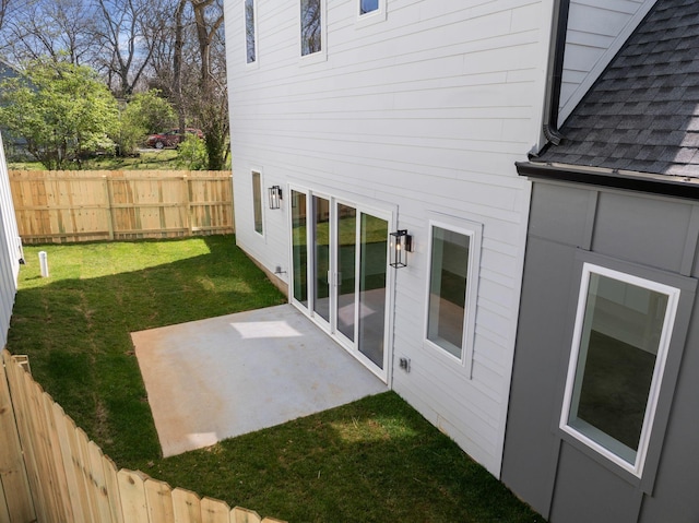 view of yard with fence and a patio