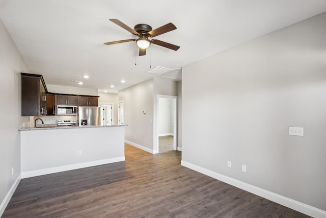 unfurnished living room with ceiling fan, recessed lighting, dark wood-style flooring, visible vents, and baseboards