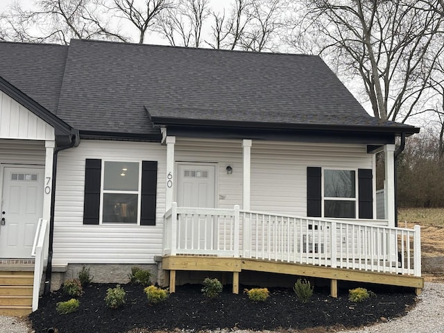 view of front of house featuring a shingled roof and board and batten siding