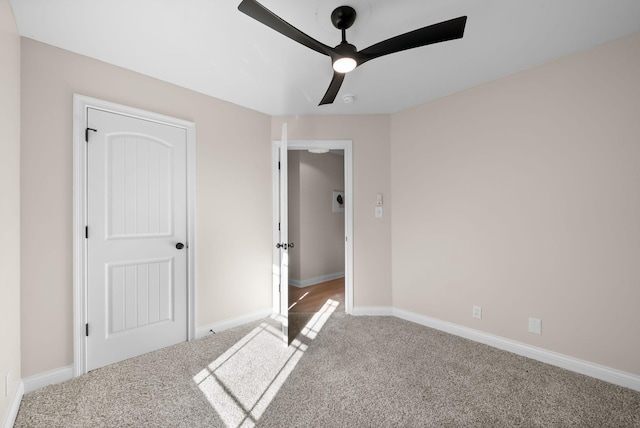 unfurnished bedroom featuring ceiling fan, carpet flooring, and baseboards