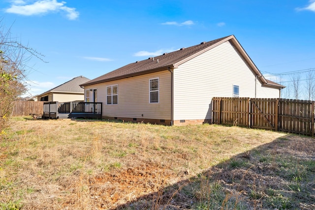 rear view of house featuring crawl space, a yard, fence, and a wooden deck