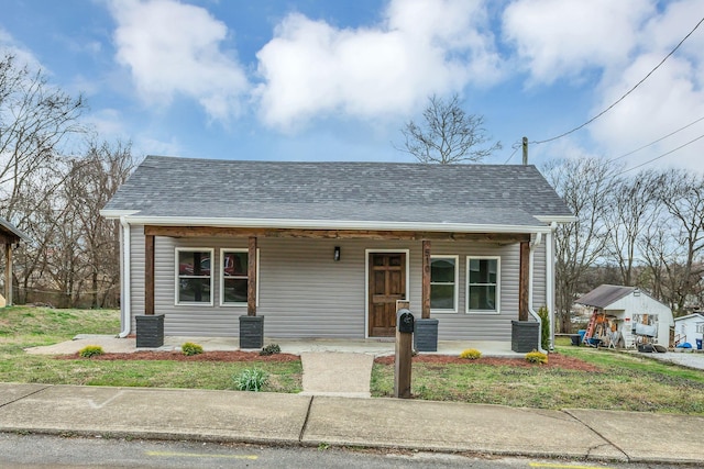 bungalow-style home featuring a shingled roof and a porch