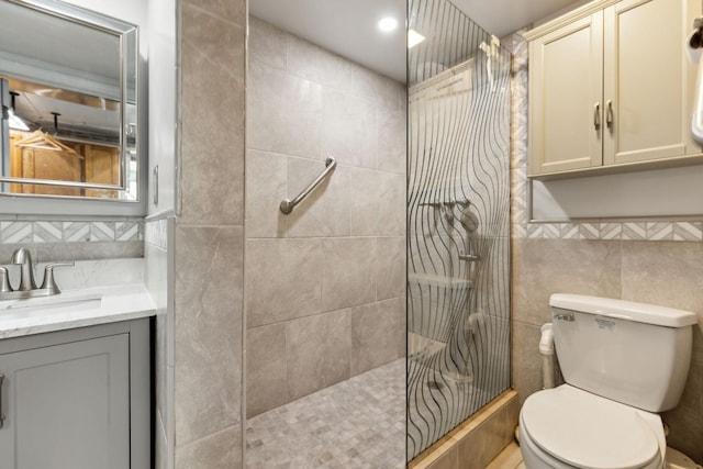 bathroom featuring tile walls, toilet, walk in shower, vanity, and backsplash